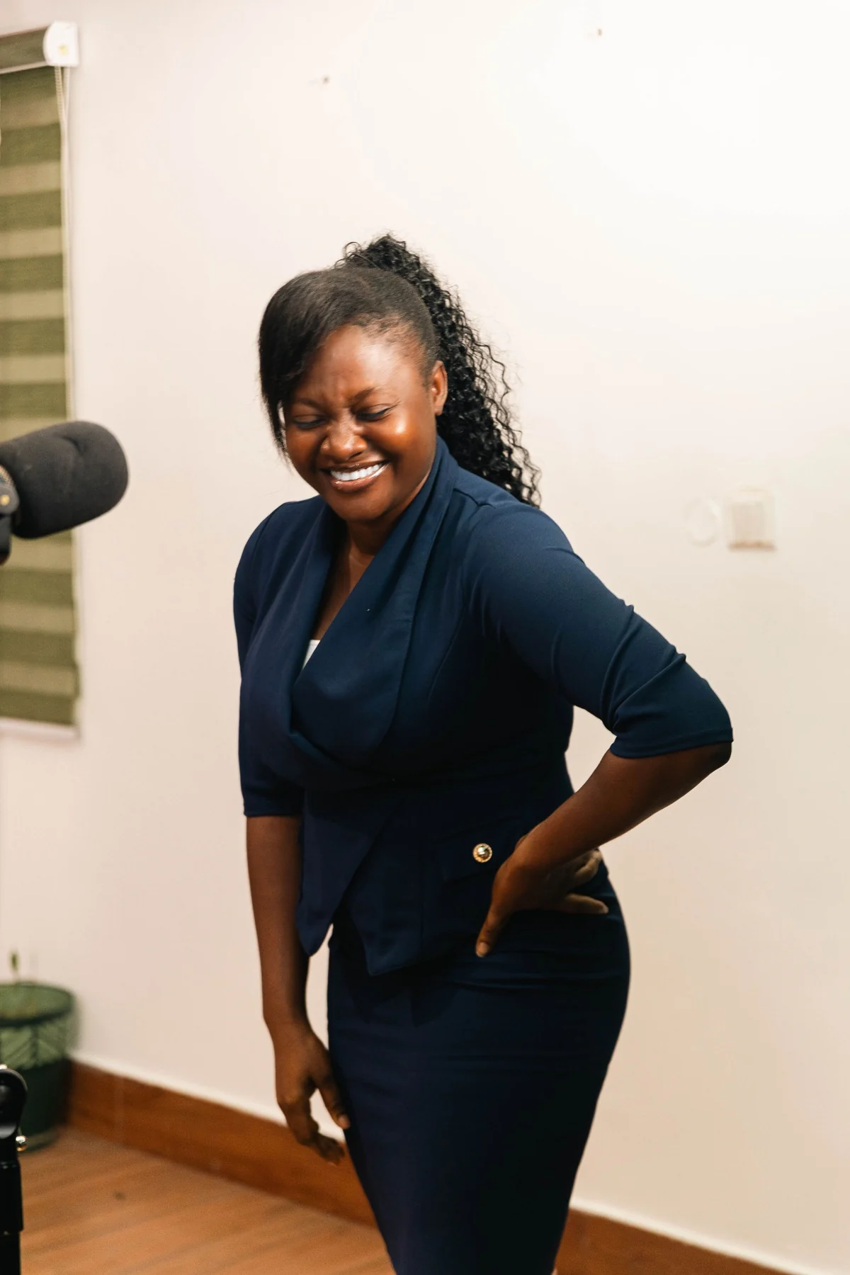 A smiling participant beside a microphone during a speaking session