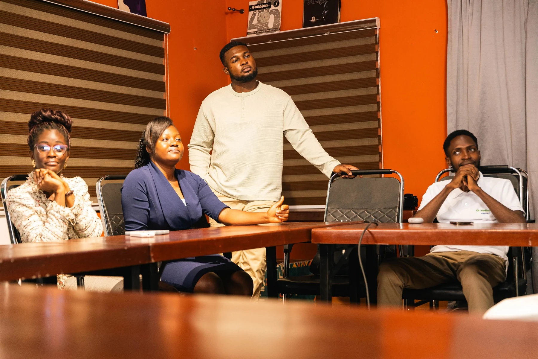 A coach and participants listening and discussing around a table